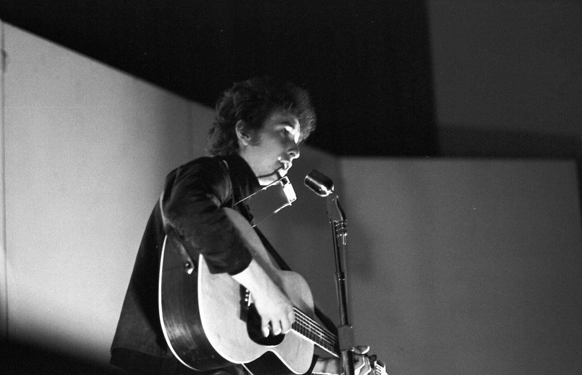 Bob Dylan at the Microphone, Unknown Location, 1964; photograph by John Byrne Cooke.