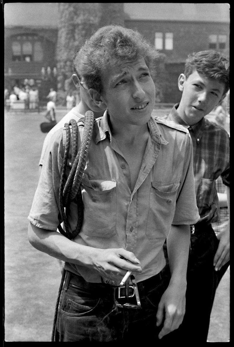 Bob Dylan with a bullwhip over his shoulder at the Newport Folk Festival in 1963, photographed by Rowland Scherman.