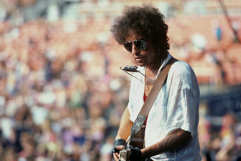 Bob Dylan Playing Harmonica, RFK Stadium, Washington, D.C., 1986. Photograph by Ebet Roberts.