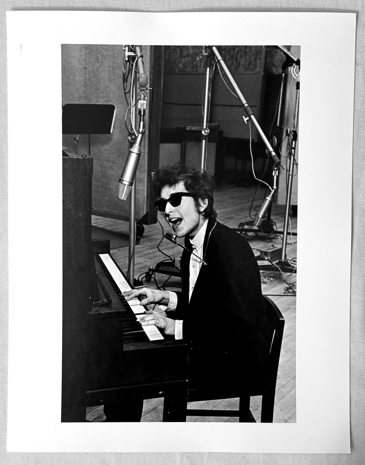 Vintage gelatin silver print of Bob Dylan singing at the piano in Columbia Studio A, New York City, 1965, photographed by Daniel Kramer.