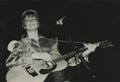David Bowie with an acoustic guitar, photographed by Mick Rock. Unique vintage gelatin silver print.