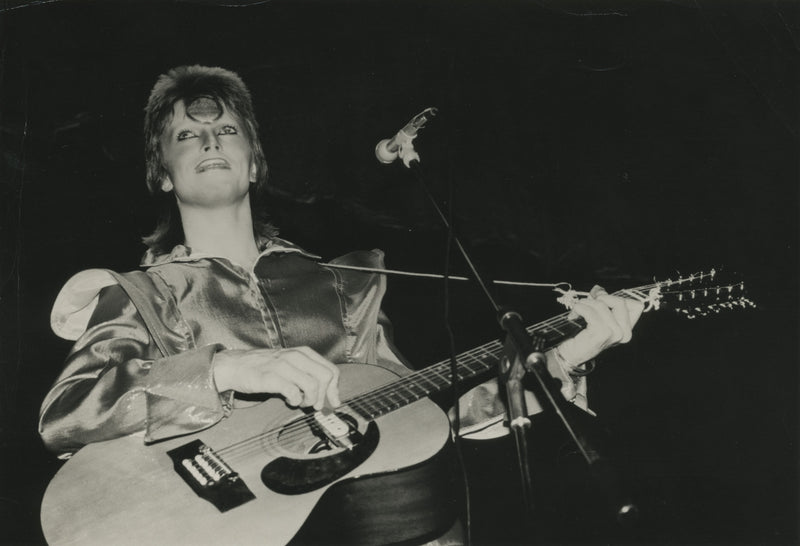 David Bowie with an acoustic guitar, photographed by Mick Rock. Unique vintage gelatin silver print.