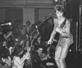 David Bowie performing at Oxford Town Hall, 1972, photographed by Mick Rock. Unique vintage gelatin silver print.