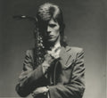 David Bowie in close-up with a saxophone, 1973 Pin Ups Sax Series, photographed by Mick Rock. Unique vintage gelatin silver print.