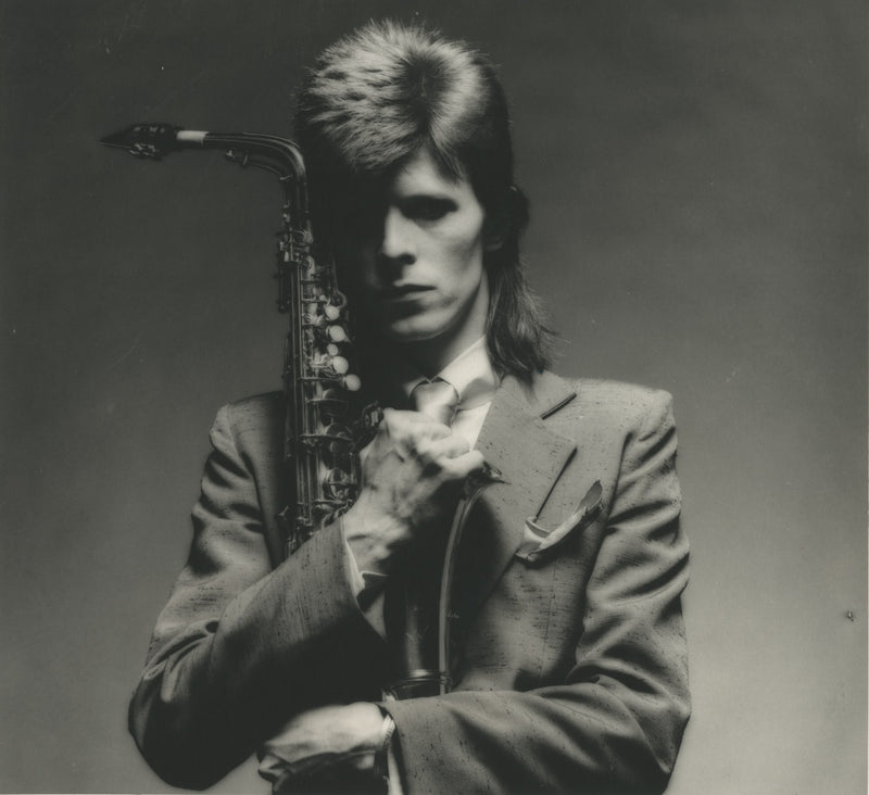 David Bowie in close-up with a saxophone, 1973 Pin Ups Sax Series, photographed by Mick Rock. Unique vintage gelatin silver print.
