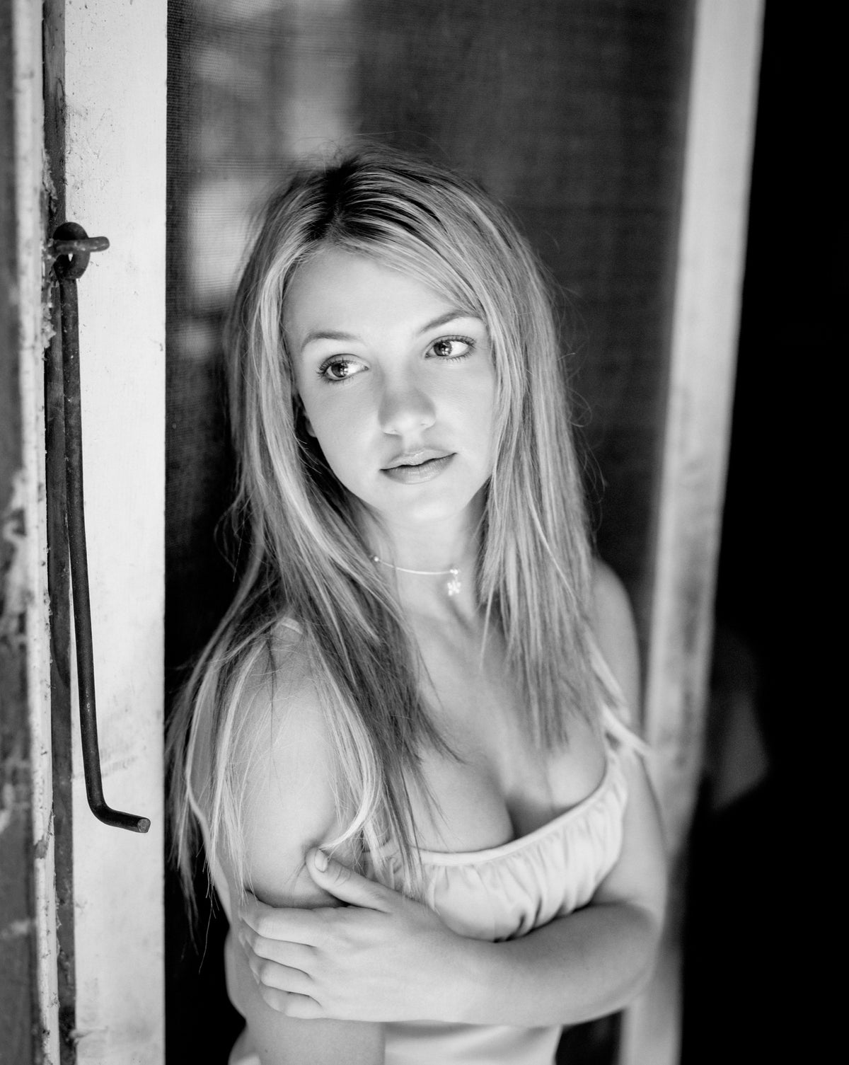 Britney Spears leans into a doorway in a close, softly lit portrait. Photograph by Timothy White, New Orleans, Louisiana, 1999.