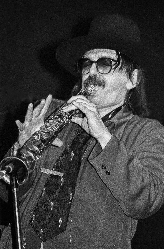 Captain Beefheart playing soprano saxophone in a hat and dark glasses, 1978, photographed by Lynn Goldsmith.