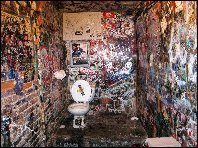 The graffiti-covered backstage toilet at CBGB, with stickers and tags on every wall, 315 Bowery, New York City, 2006, photographed in color by David Corio.
