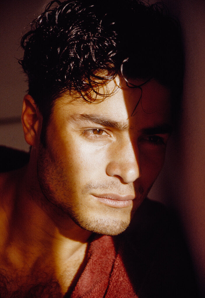 Close portrait of Chayanne in a red shirt, in color, 1993, photographed by Lynn Goldsmith.