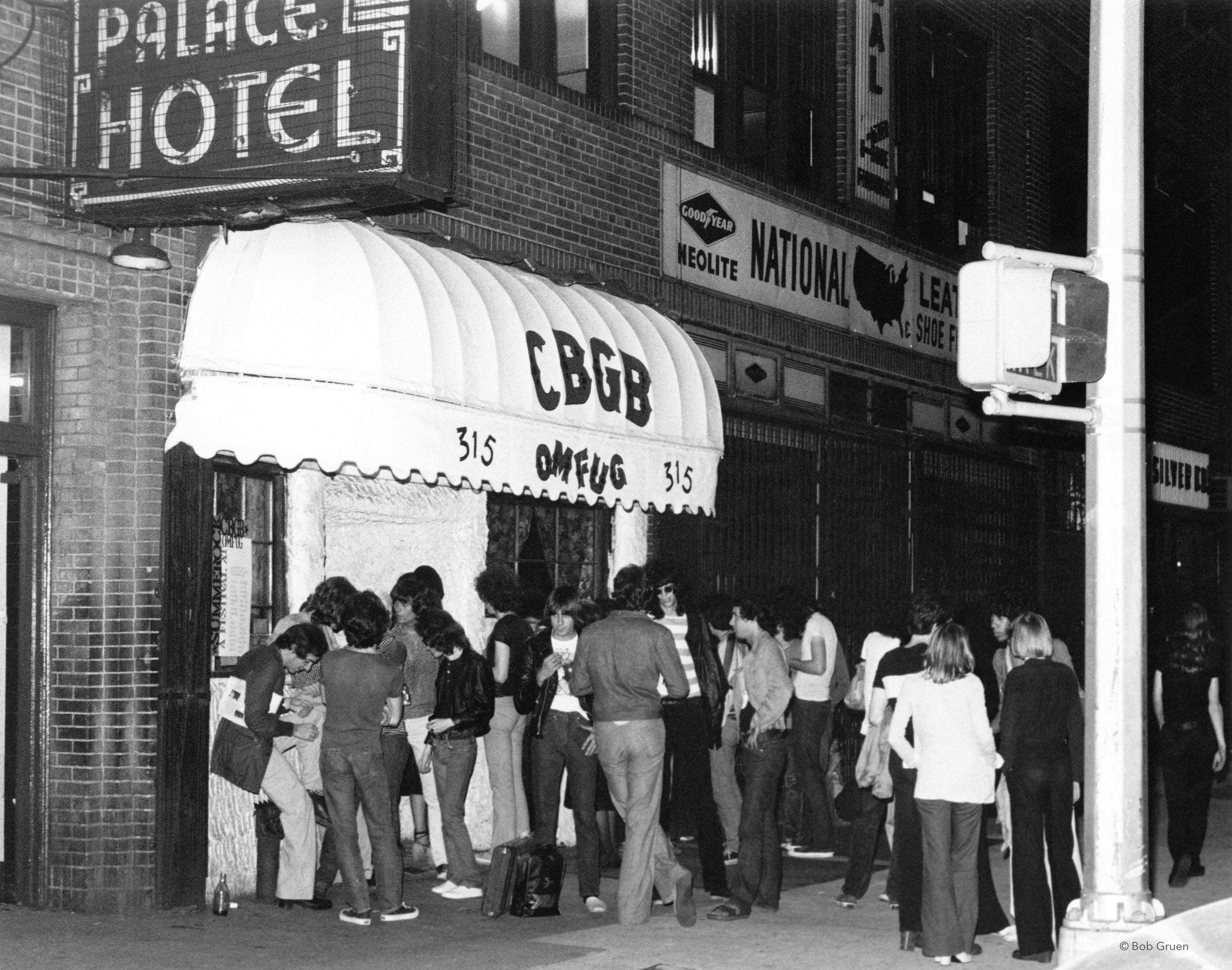 Danny Fields, Joey Ramone and David Johansen outside CBGB in New York City, photographed by Bob Gruen in 1977.