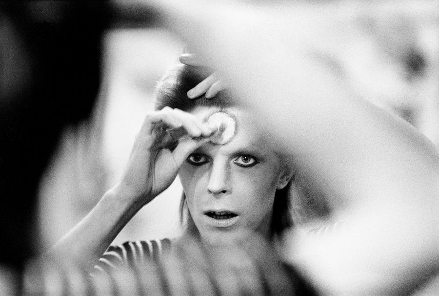 David Bowie Applying Makeup, 1973, photographed by Mick Rock.