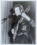 David Bowie with a guitar, London, 1972, photographed by Mick Rock. Unique vintage gelatin silver print.