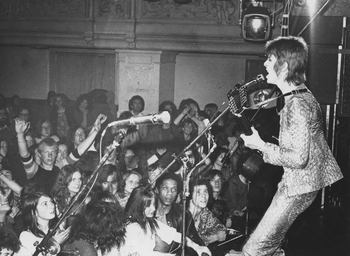 David Bowie performing live at Oxford Town Hall, 1972, photographed by Mick Rock. Unique vintage silver print.