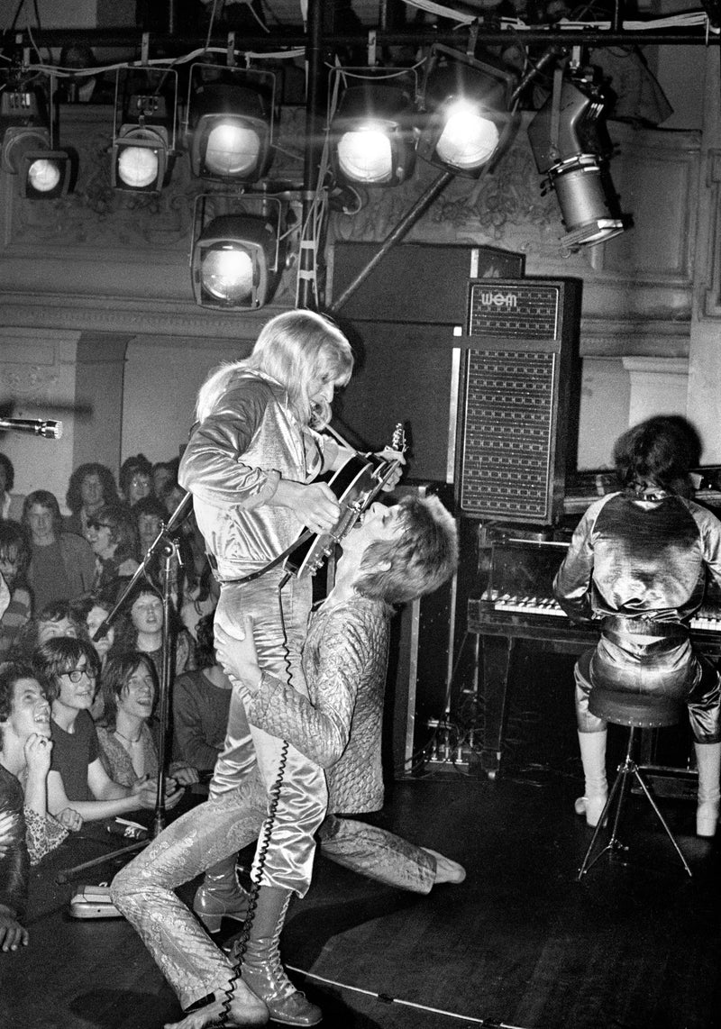 David Bowie and Mick Ronson, Guitar Fellatio, 1972, photographed by Mick Rock.