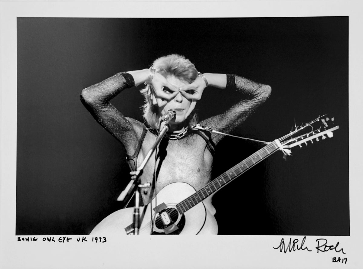 David Bowie on stage in the UK, 1973, hands framing his eyes in the ‘Owl Eye’ gesture — photograph by Mick Rock, a signed, hand-titled late print.