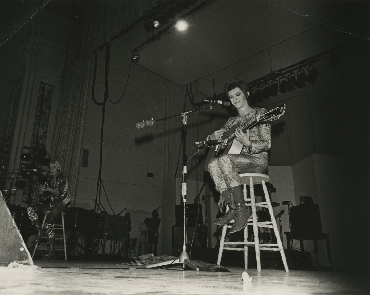 Black-and-white photograph of David Bowie performing at Oxford Town Hall in 1972, taken by Mick Rock — vintage gelatin silver print