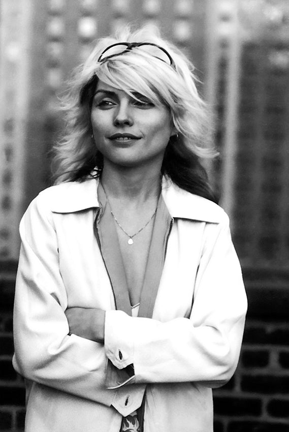 Debbie Harry with arms folded and sunglasses in her hair on the Record Plant studios rooftop, New York City, black-and-white photograph by Martyn Goddard, 1978.