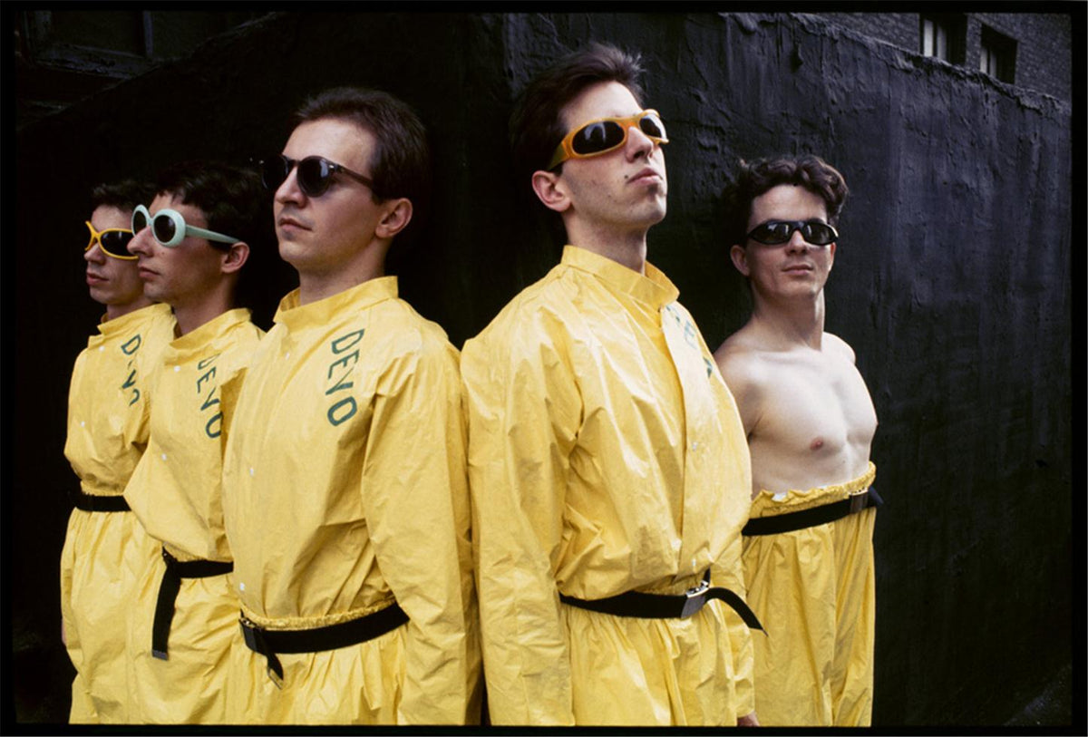 Devo in yellow jumpsuits, photographed in color by Chris Stein.