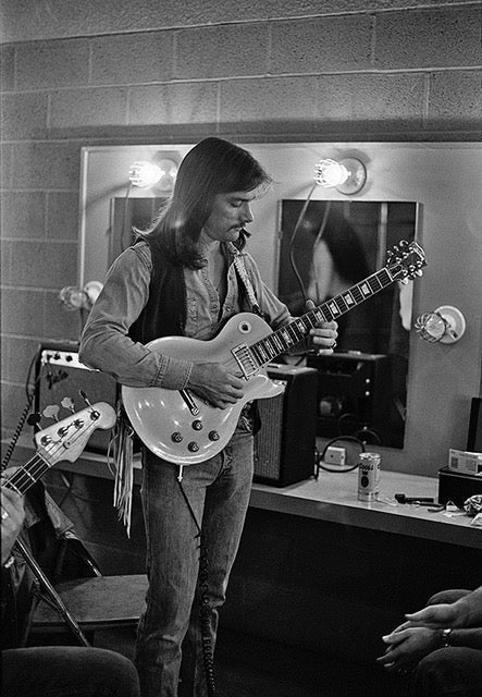 Dickey Betts of the Allman Brothers Band performing with his guitar in Austin, Texas, photographed by Charlyn Zlotnik, 1976.