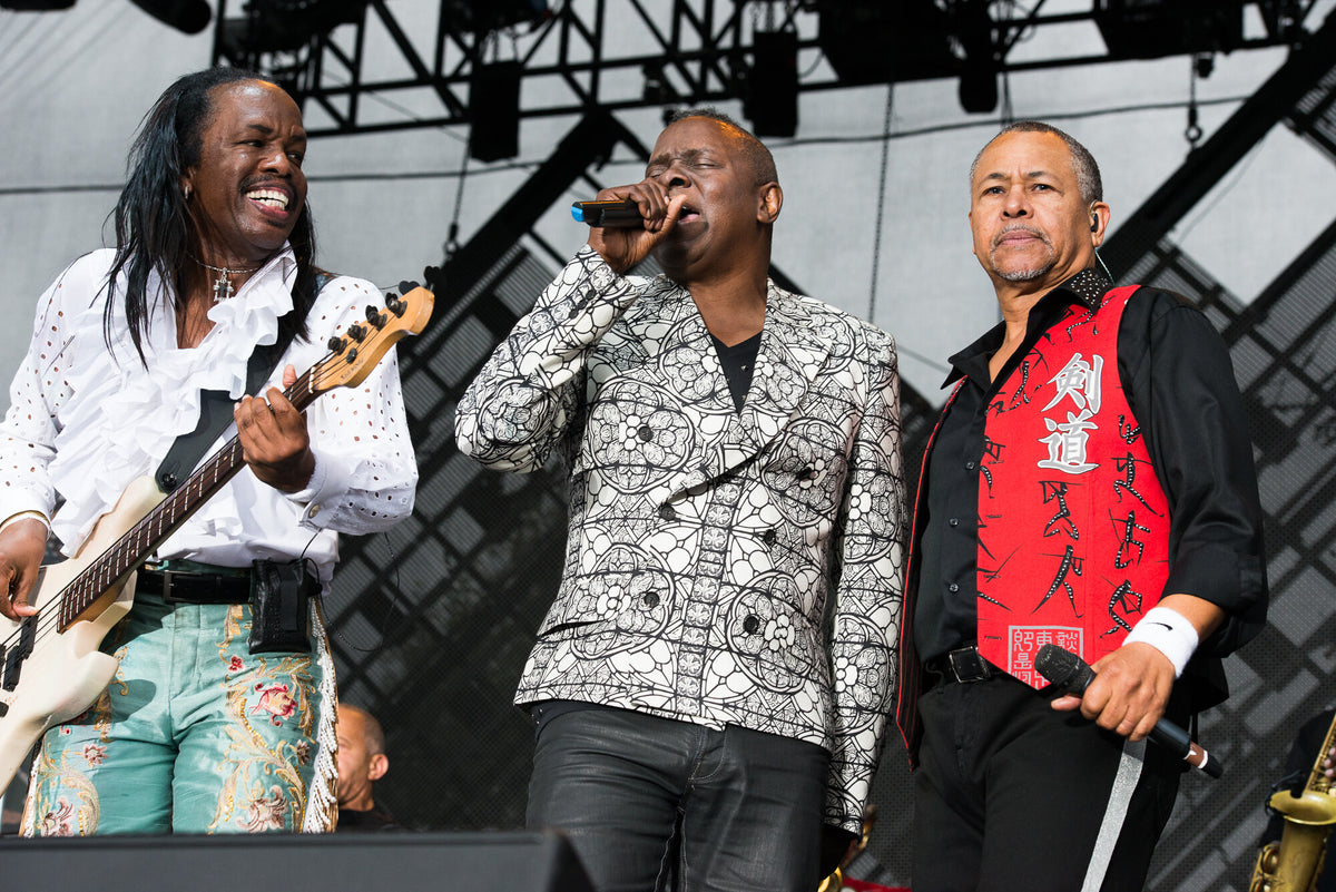 Earth, Wind & Fire performing on an outdoor stage, in color, 2014, photographed by Lynn Goldsmith.