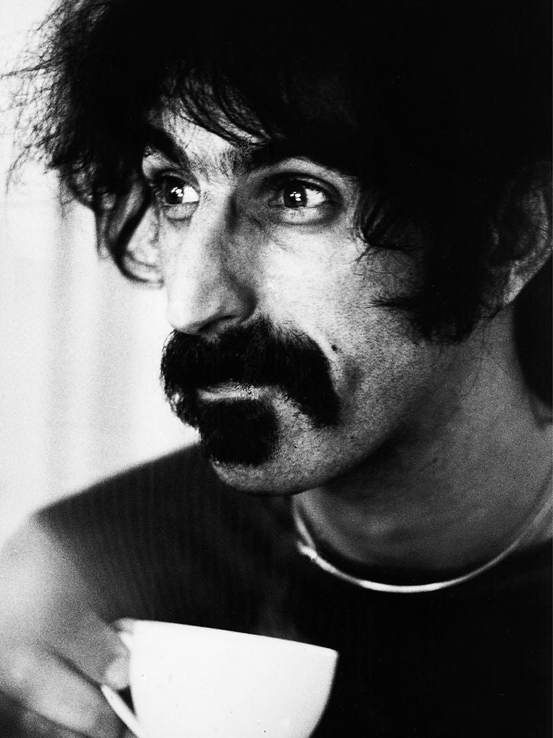 Frank Zappa holding a cup and looking to one side in 1972. Photograph by Gijsbert Hanekroot.