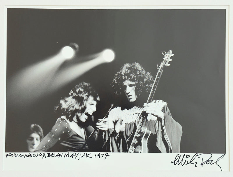 Freddie Mercury and Brian May performing in the UK, 1974, hand-titled and signed by Mick Rock.