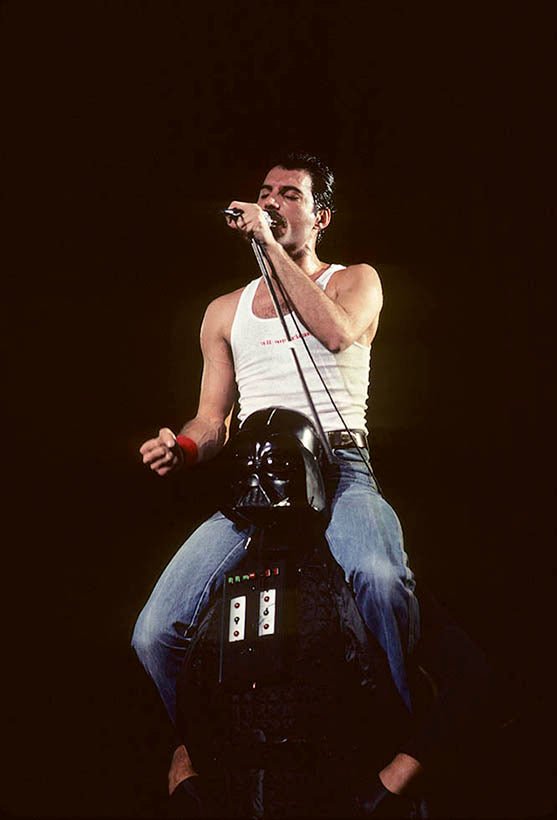 Freddie Mercury of Queen photographed alongside a costumed Darth Vader by Charlyn Zlotnik.