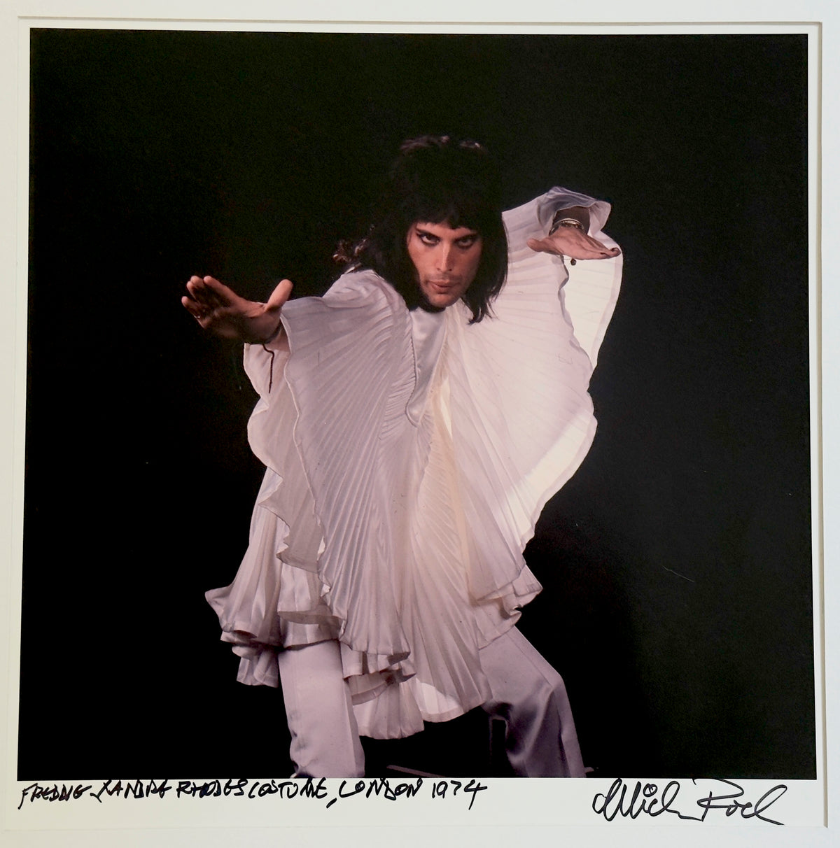 Freddie Mercury of Queen in the pleated ‘wing’ costume by Zandra Rhodes, London, 1974 — photograph by Mick Rock, a signed, hand-titled late print.