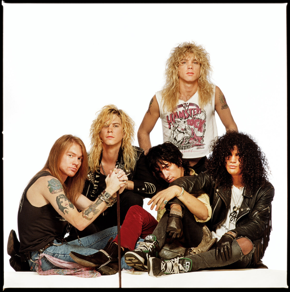 The members of Guns N’ Roses cluster together against a plain studio backdrop. Photograph by Timothy White, Harrison, New Jersey, 1988.