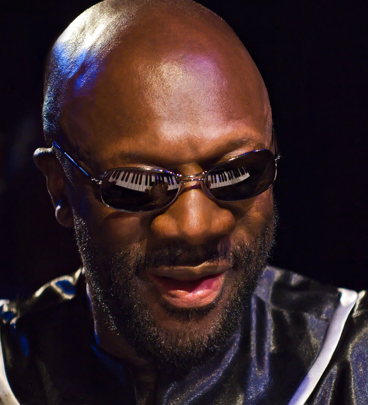 Close portrait of Isaac Hayes in tinted sunglasses, in color, 2005, photographed by Lynn Goldsmith.