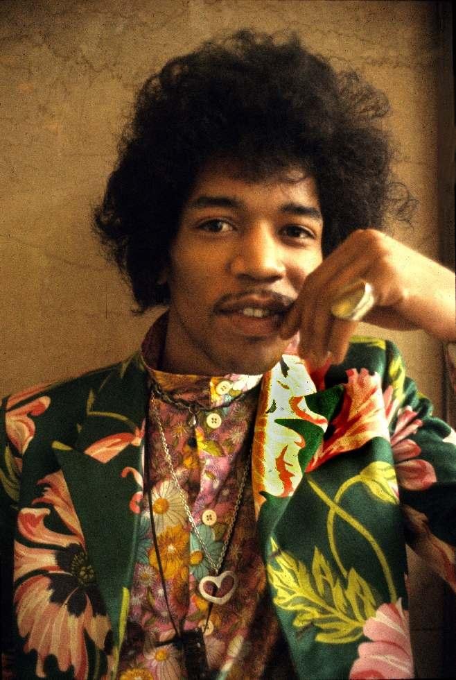 Colour portrait of Jimi Hendrix in a floral suit, 1967, photographed by Barrie Wentzell.