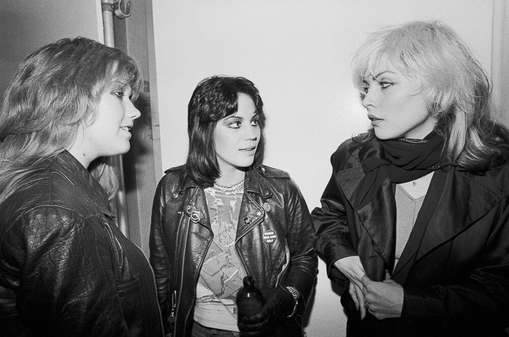 Joan Jett and Vicki Blue of The Runaways with Debbie Harry, in black and white, 1978, photographed by Lynn Goldsmith.