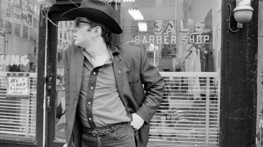 Joe Strummer in a barber shop, New York City, 1980, photographed by Roberta Bayley.