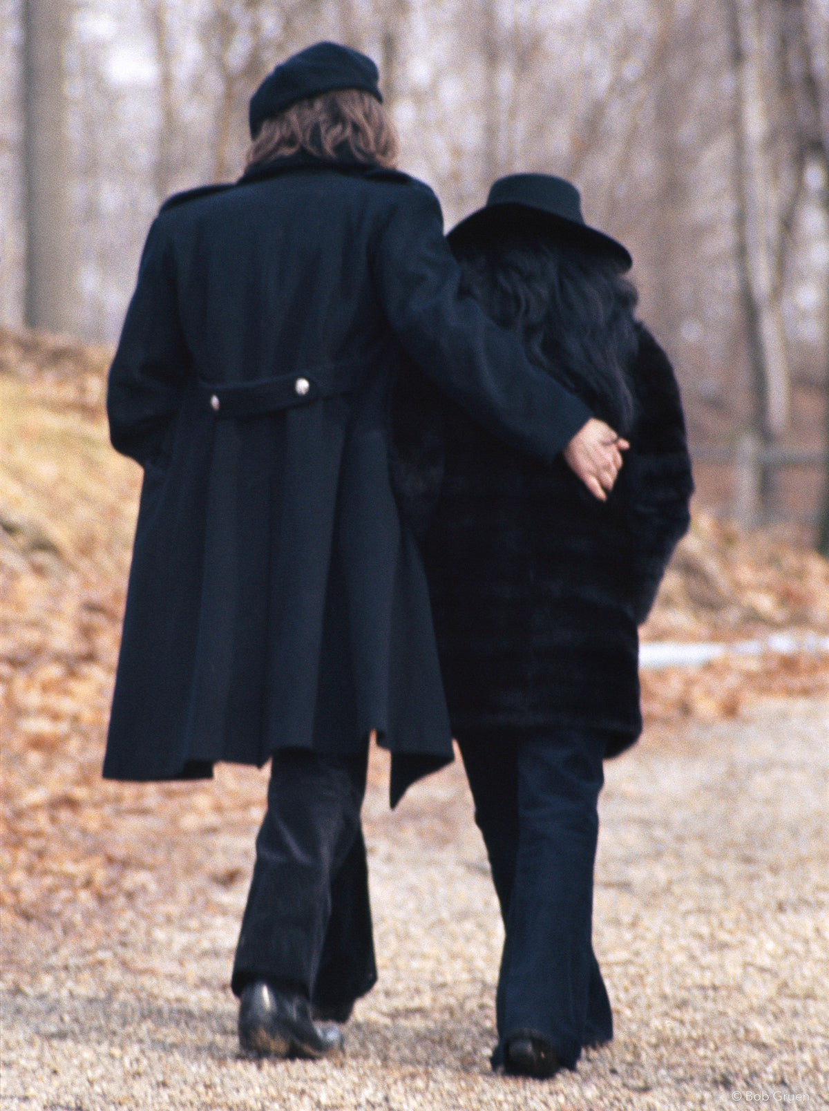 John Lennon and Yoko Ono walking away together in New York City, 1973, photographed by Bob Gruen.