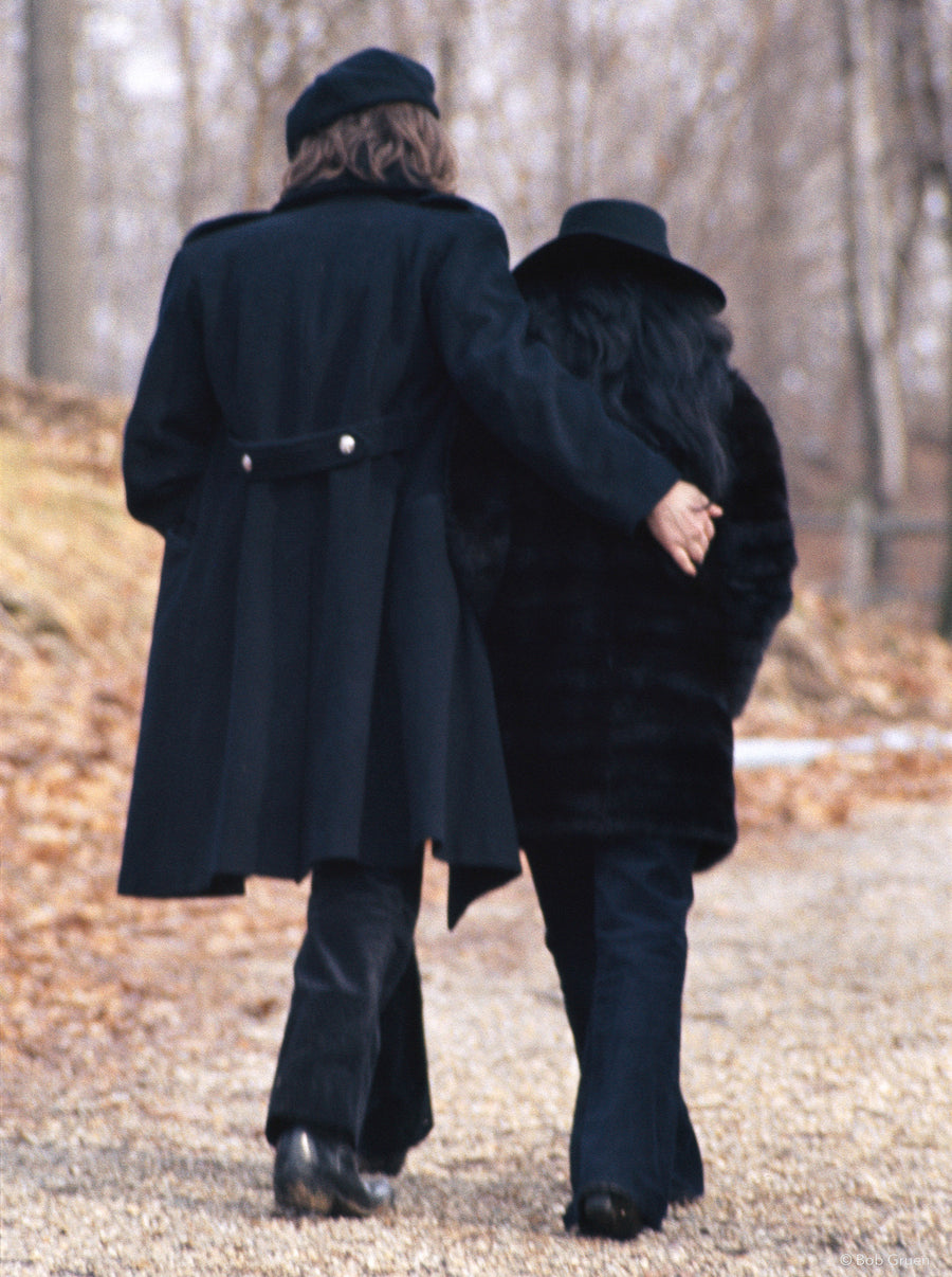 John Lennon and Yoko Ono walking away together in New York City, 1973, photographed by Bob Gruen.
