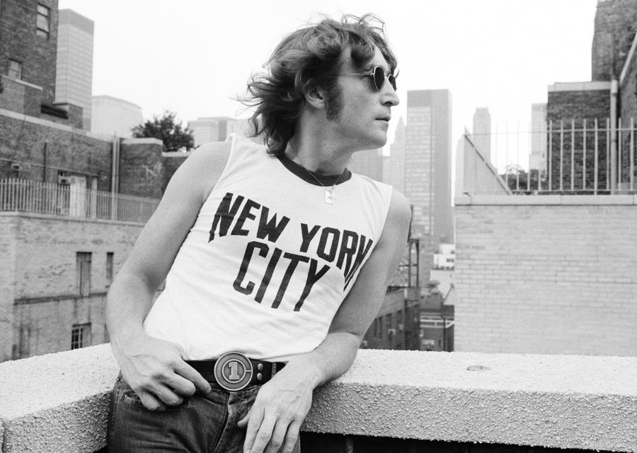 Profile portrait of John Lennon wearing his iconic NYC T-Shirt in New York City, 1974, photographed by Bob Gruen.