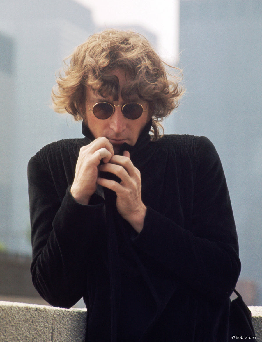 John Lennon making a playful gesture in New York City, 1974, photographed by Bob Gruen.