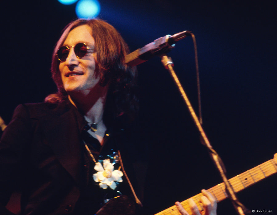 John Lennon with guitar on stage at Madison Square Garden, New York City, 1974, photographed by Bob Gruen.