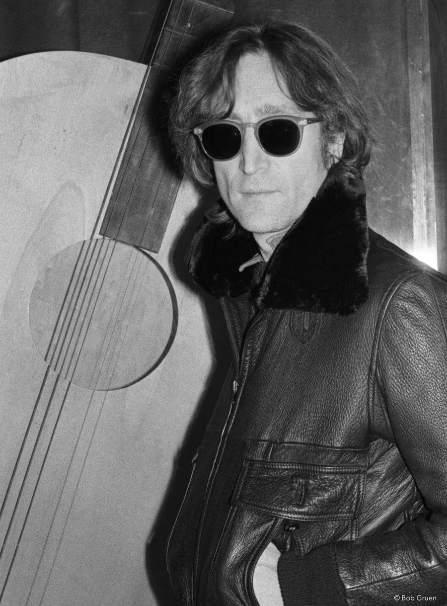 John Lennon with a guitar sculpture in New York City, 1980, photographed by Bob Gruen.