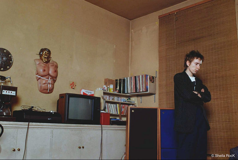 John Lydon in interior, Chelsea, 1980, photographed by Sheila Rock.
