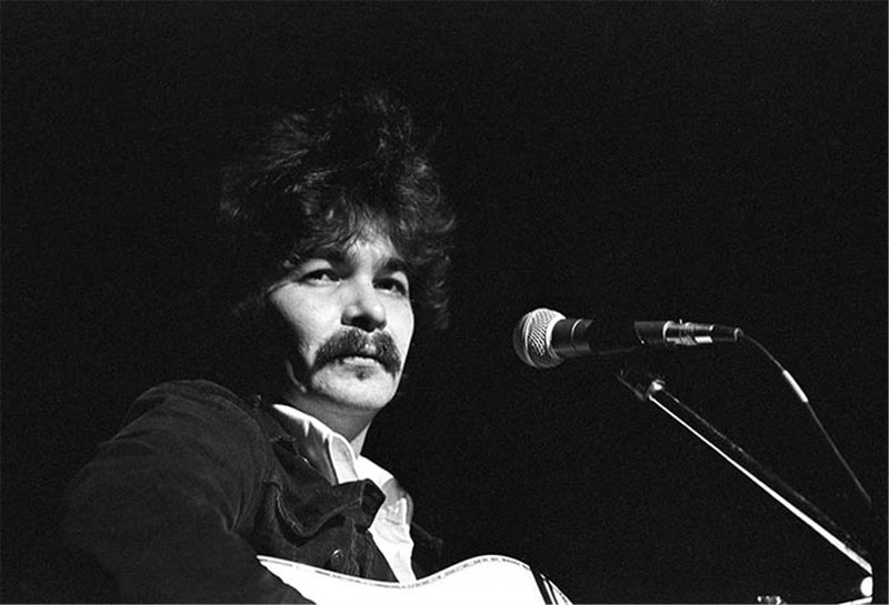 John Prine performing at the Paramount Theater in Austin, Texas, photographed by Charlyn Zlotnik, 1977.