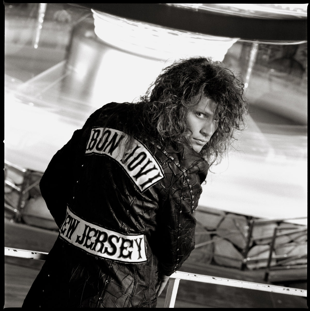 Jon Bon Jovi turns toward the camera, displaying the lettering on the back of his jacket. Photograph by Timothy White, Seaside Heights, New Jersey, 1988.
