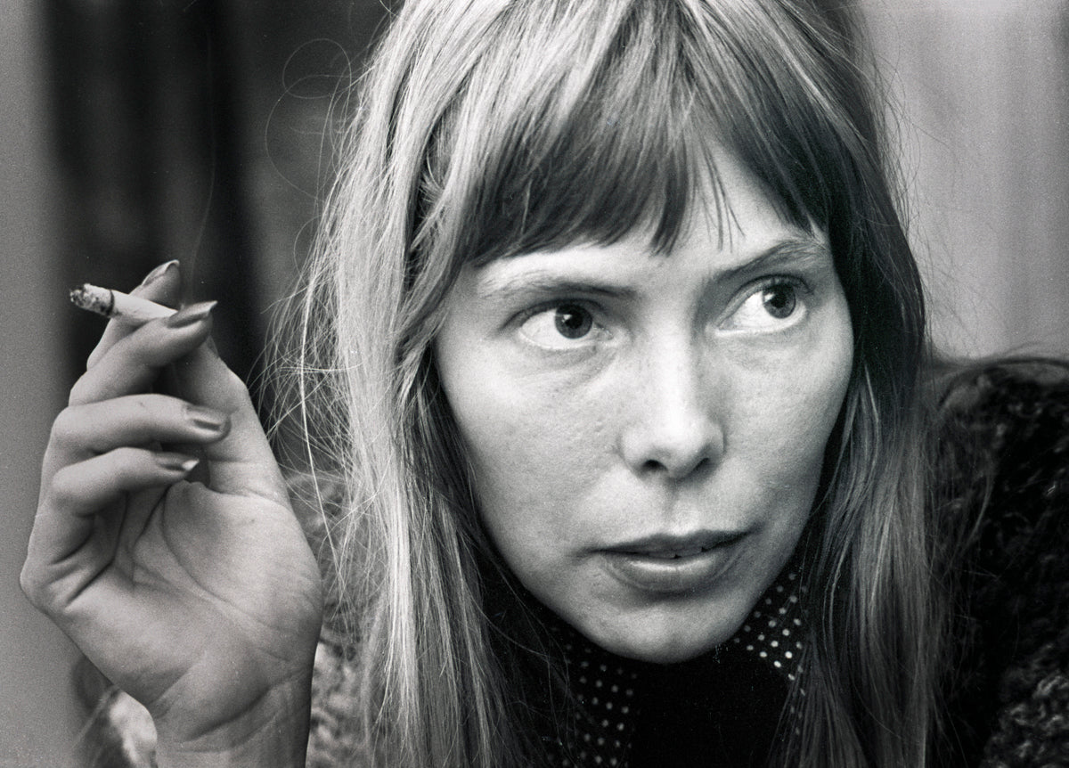 Joni Mitchell holding a cigarette during a close-up portrait in 1972. Photograph by Gijsbert Hanekroot.