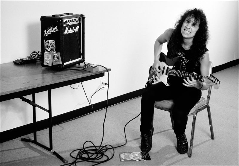 Kirk Hammett of Metallica warming up backstage during the Damage, Inc. Tour, 1986, photographed by Mark Weiss.