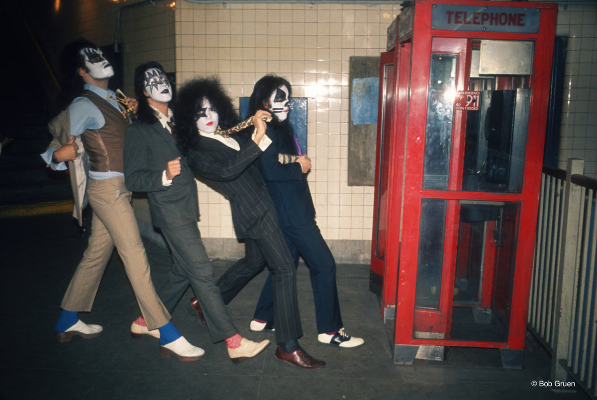 Members of Kiss entering a phone booth in New York City, 1974, photographed by Bob Gruen.