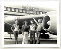Original vintage gelatin silver print of Led Zeppelin in front of their tour plane, the Starship, New York City, 1973, photographed by Bob Gruen.