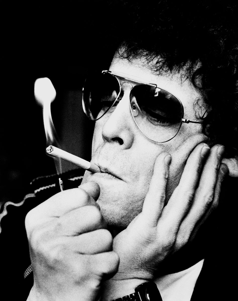 Lou Reed smoking with his face resting in one hand in 1972. Photograph by Gijsbert Hanekroot.