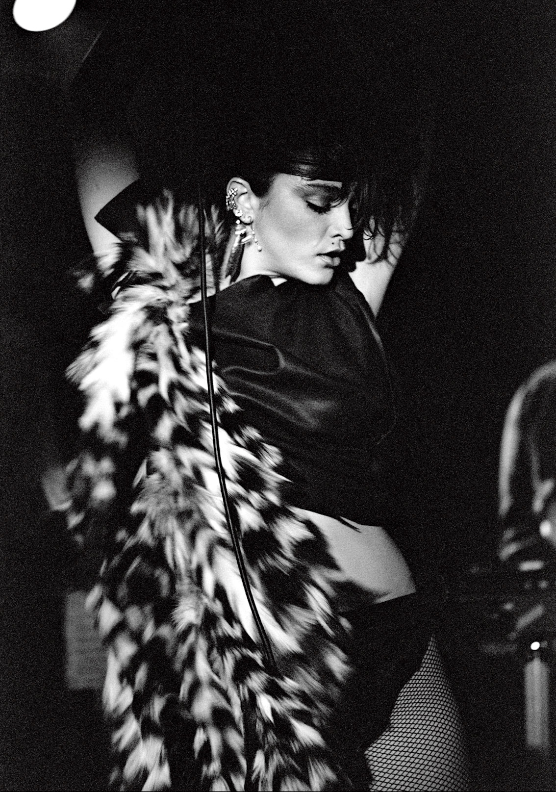 Madonna, backstage portrait wearing a feather boa, photographed by George DuBose.