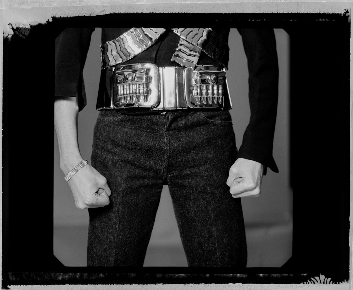 A tightly cropped view concentrates on Michael Jackson’s clenched fists, belt and decorated jacket. Photograph by Timothy White, New York City, 1994.