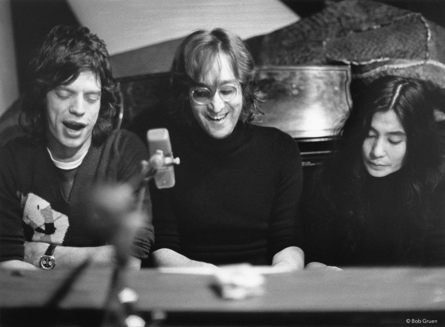Mick Jagger, John Lennon and Yoko Ono looking toward the piano, New York City, 1972, photographed by Bob Gruen.